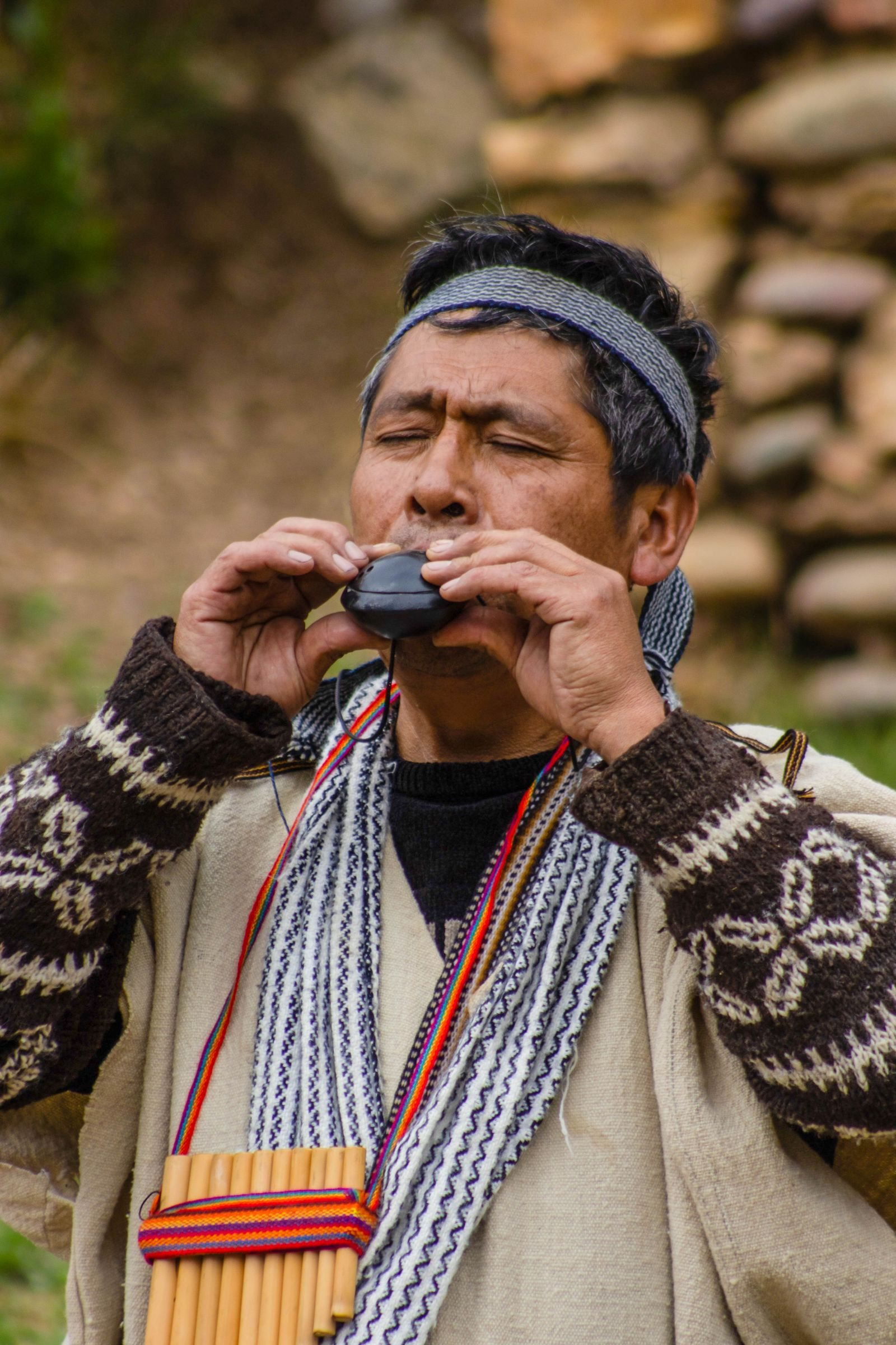 Stock photo: a musician with panpipes at his chest